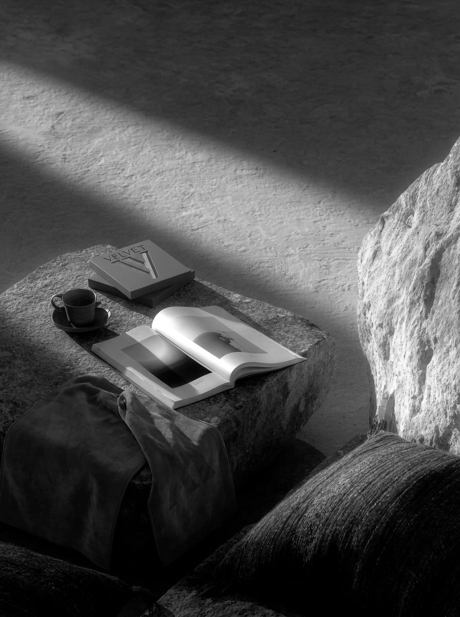A VELVET box, a book and a towel on stone