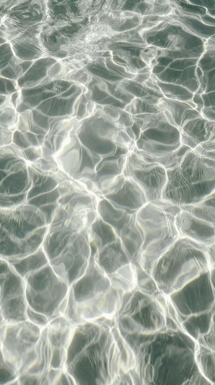 Sunlight rippling across pool water