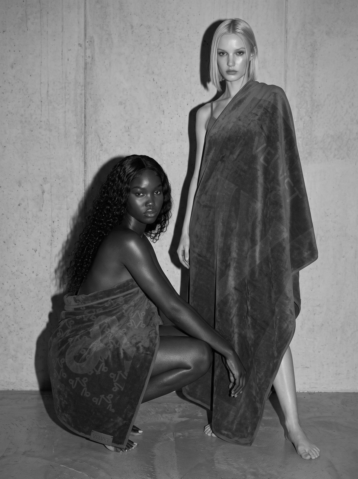 A full-length VELVET bath sheet worn from shoulder to floor, black and white