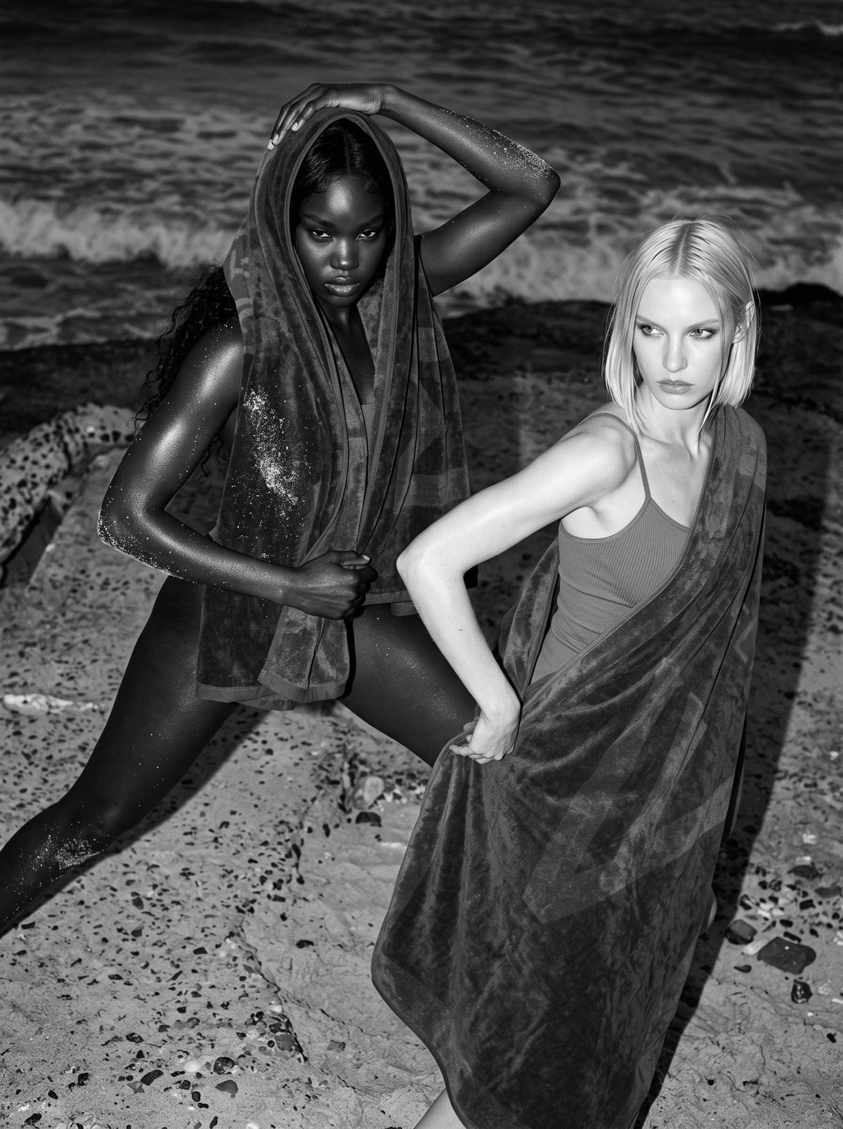 Two women on wet rocks wrapped in VELVET towels, black and white
