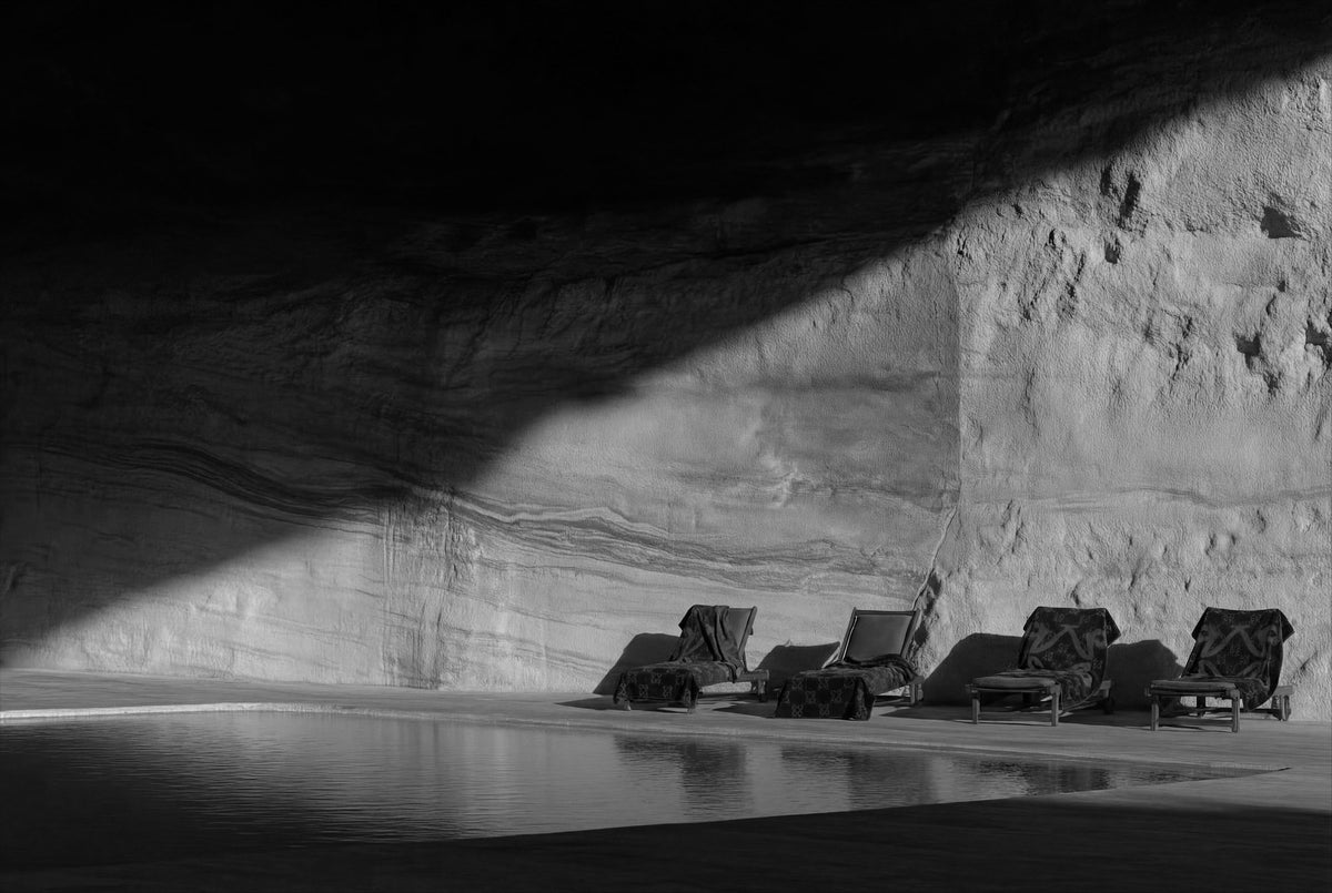 Loungers beside a pool carved into a canyon
